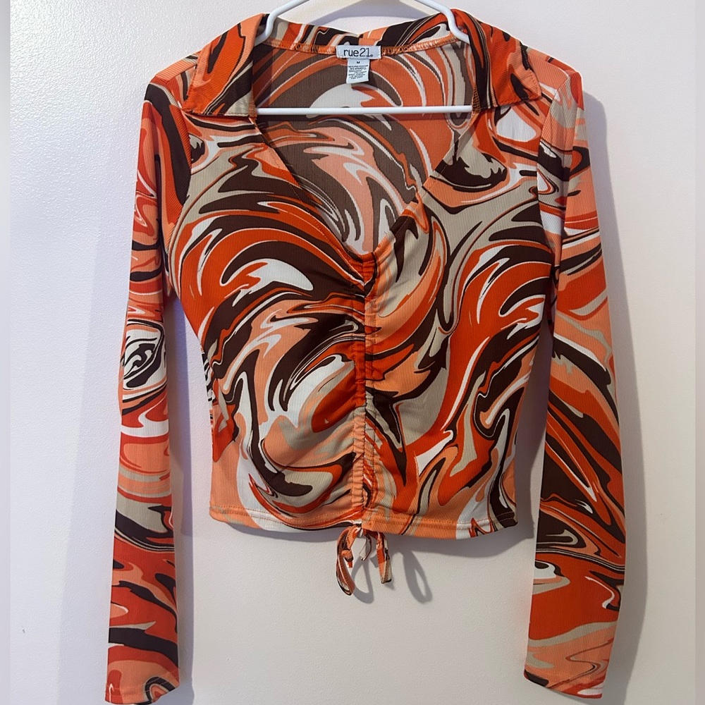 Orange, brown, black and white collared blouse. Draw string on front.